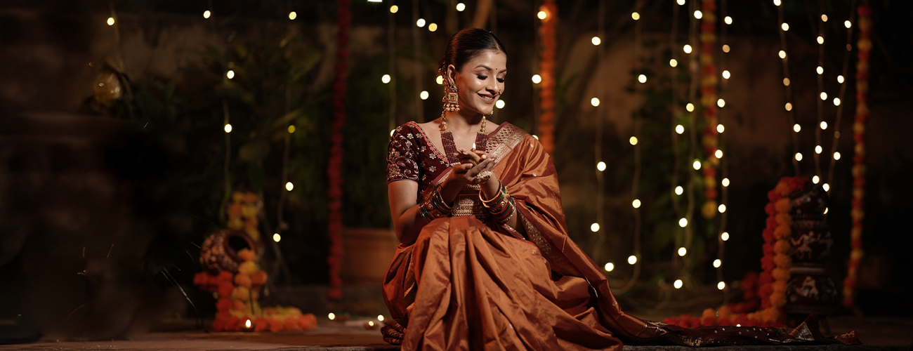 A South Asian lady wearing a saree, celebrating Deepavali.