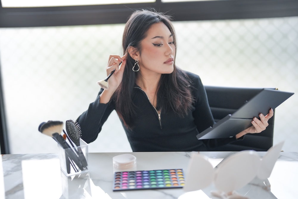 woman holding makeup brush