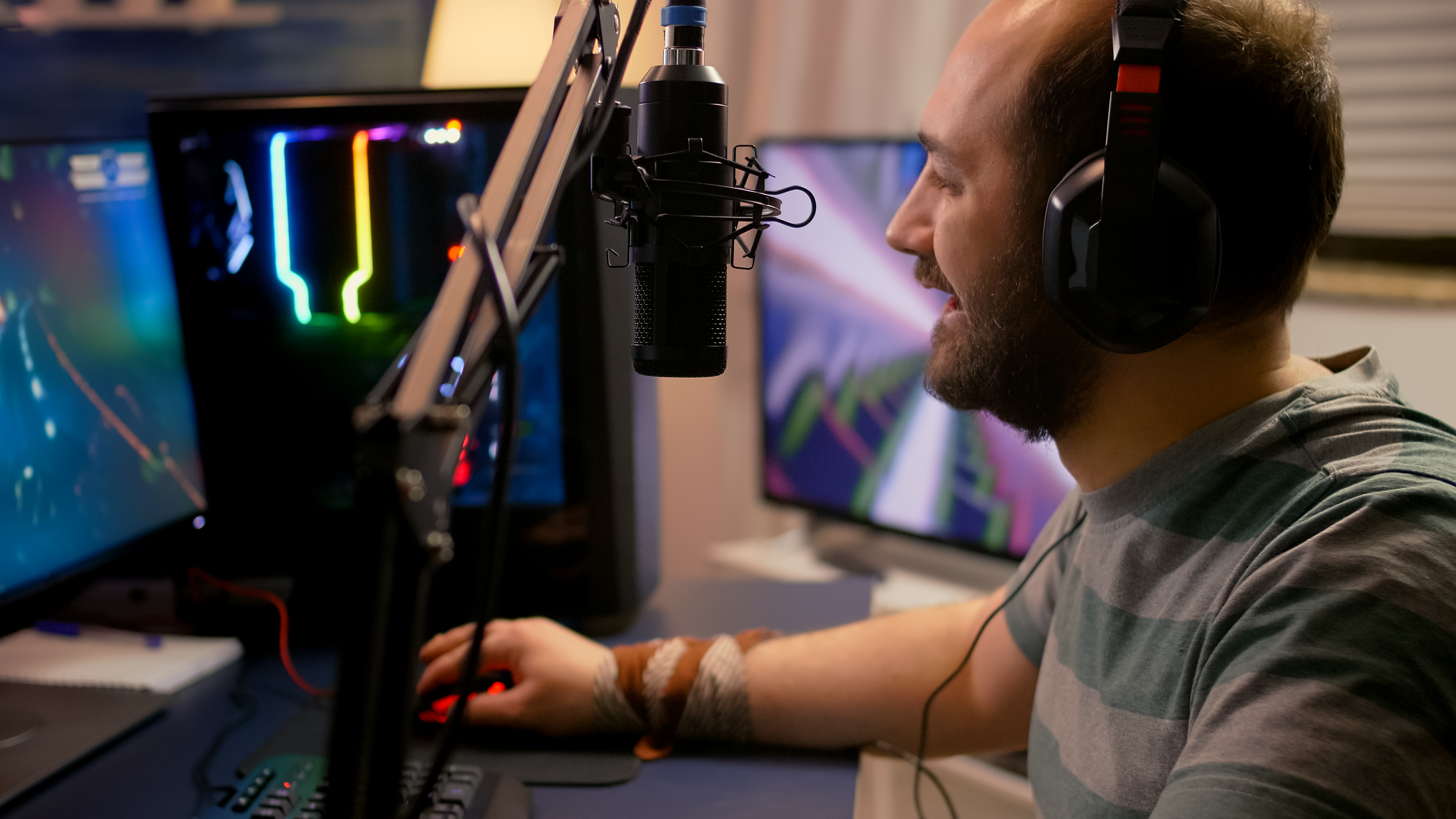 Gamer streaming live to fans while using a microphone