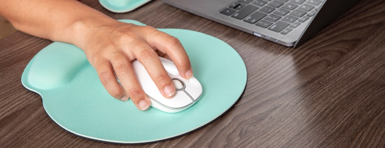 Person using a wireless mouse on a table