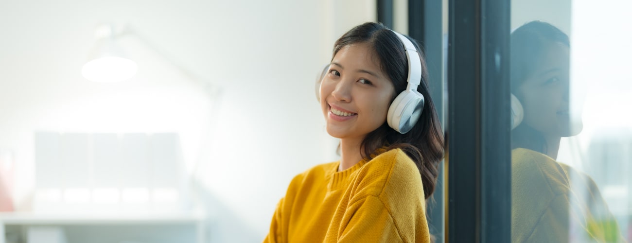 young woman enjoying music with wireless headphones