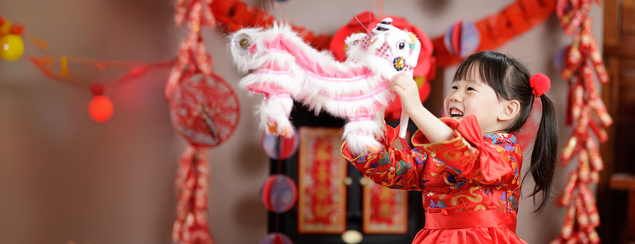 girl playing with lion toy during cny