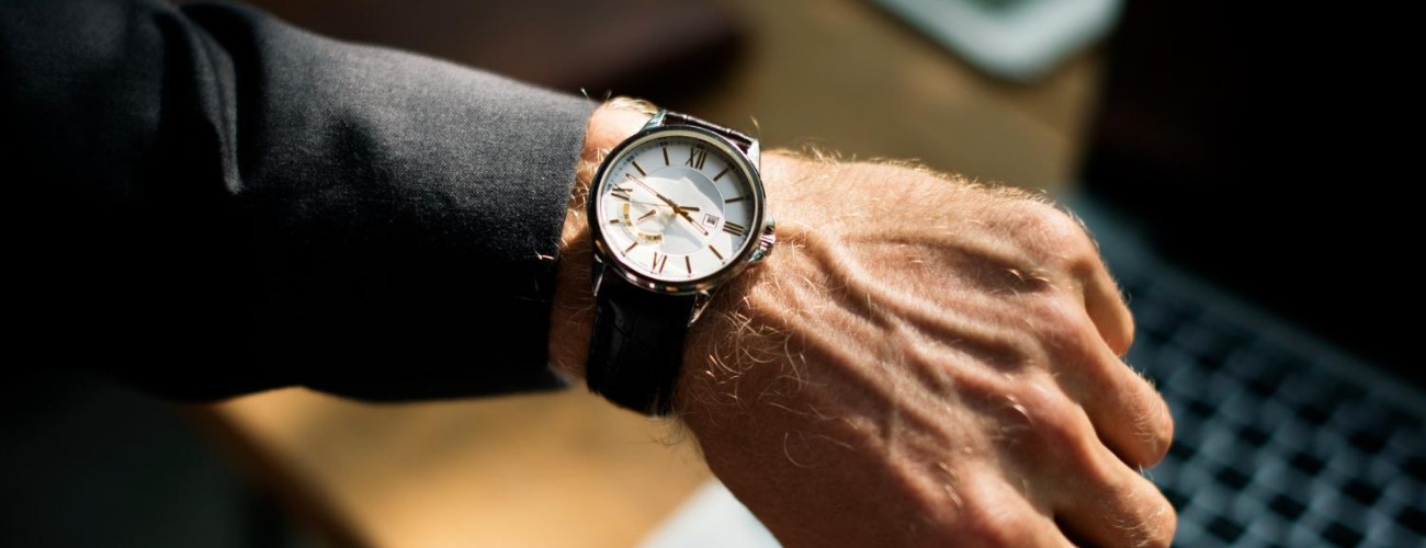 A luxury watch on the wrist of a business man.